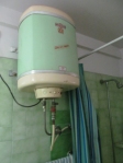 small waterheater that is in a bathroom and kitchen.