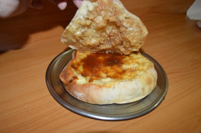 Komplet lepinja. Specialty from Uzice, Serbia.  Grease from a roasted lamb on bread with egg and kajmak